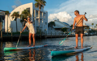 Two people on paddle boards in water