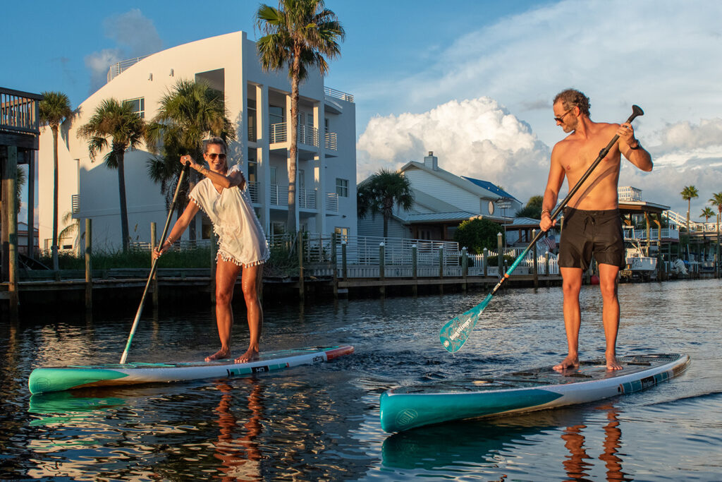 Two people on paddle boards in water