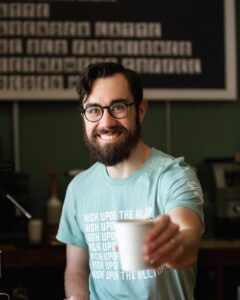 Smiling guy with coffee cup