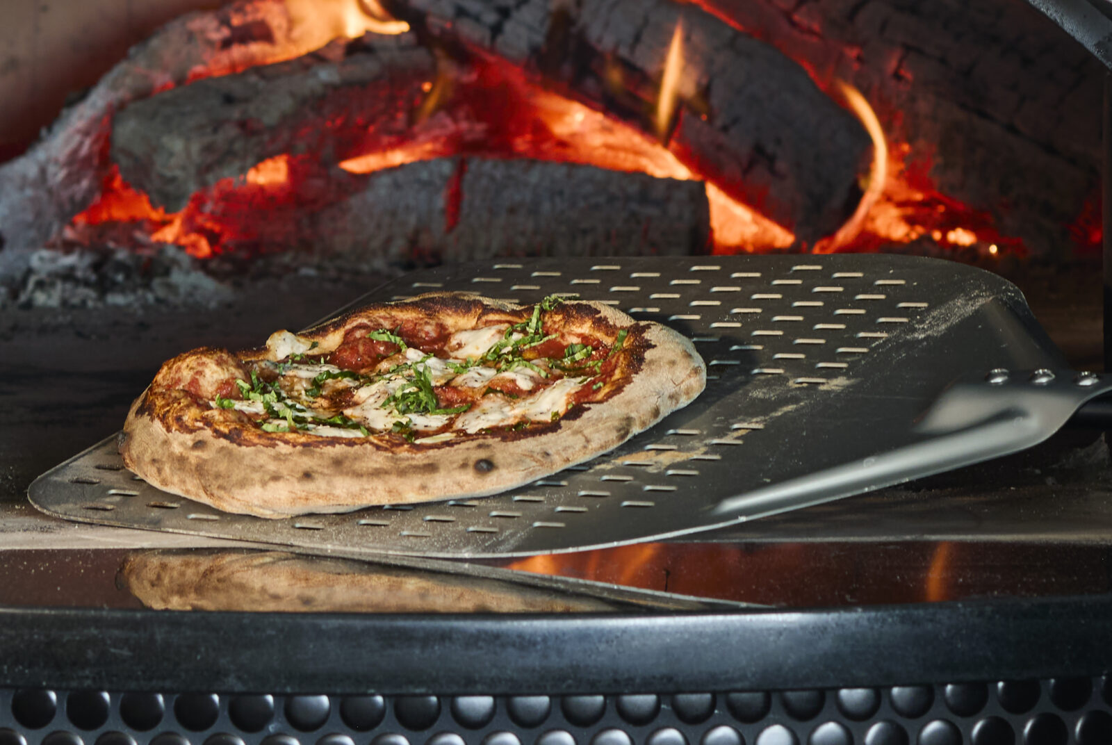 Pizza coming out of the oven