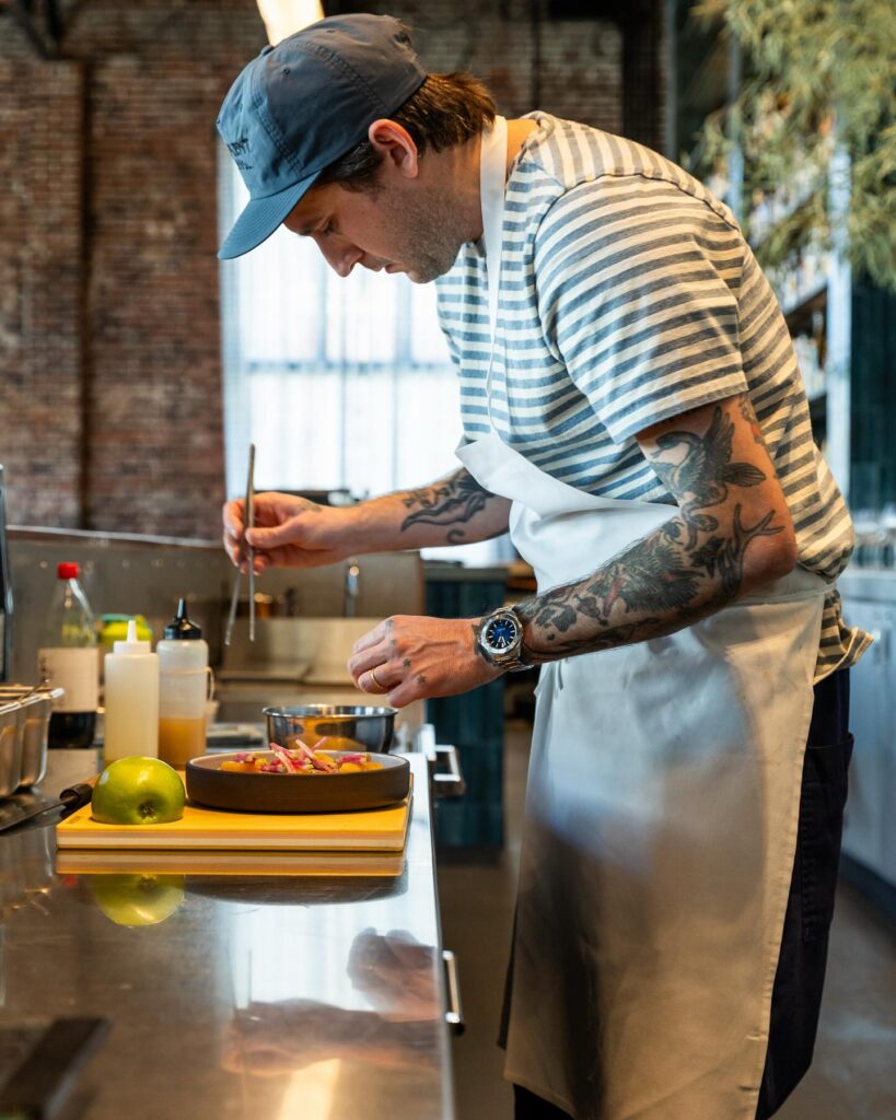 Luke Joseph plating a dish