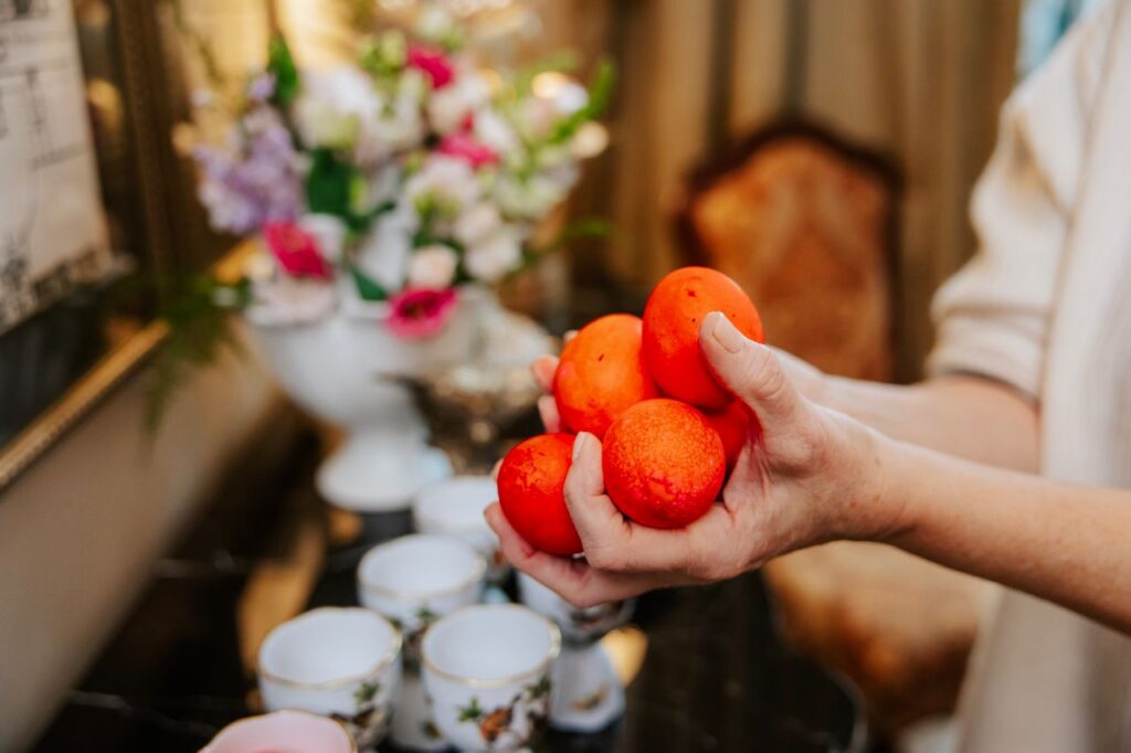Holding red easter eggs