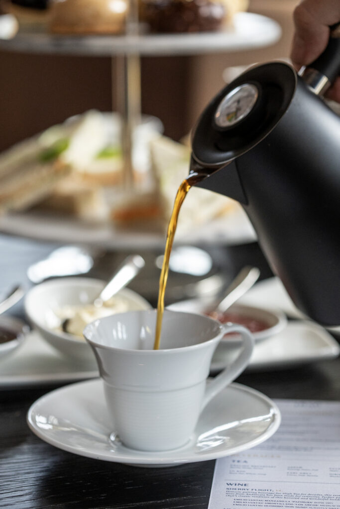 Pouring tea into a teacup