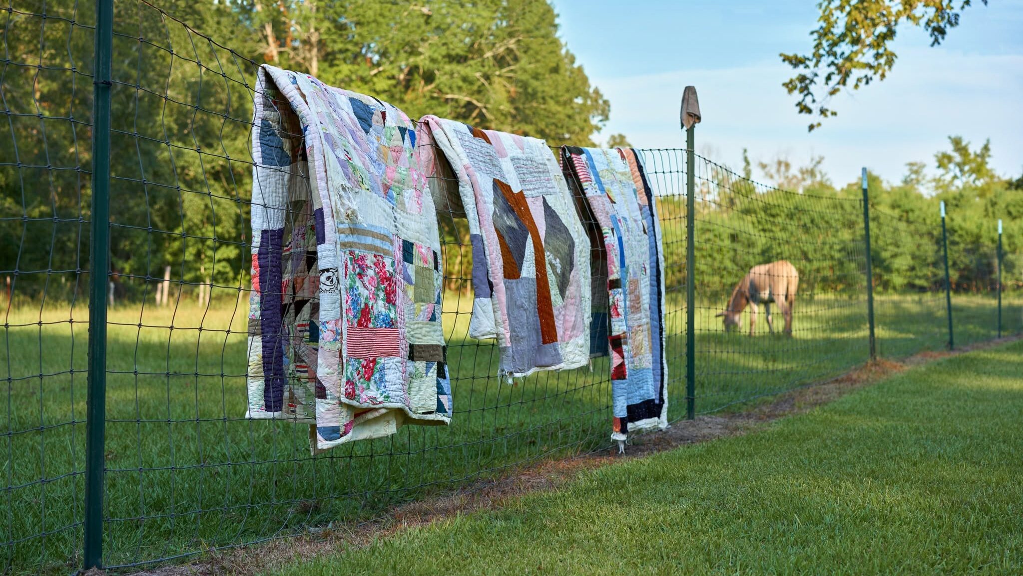 Gee's Bend quilts on a fence
